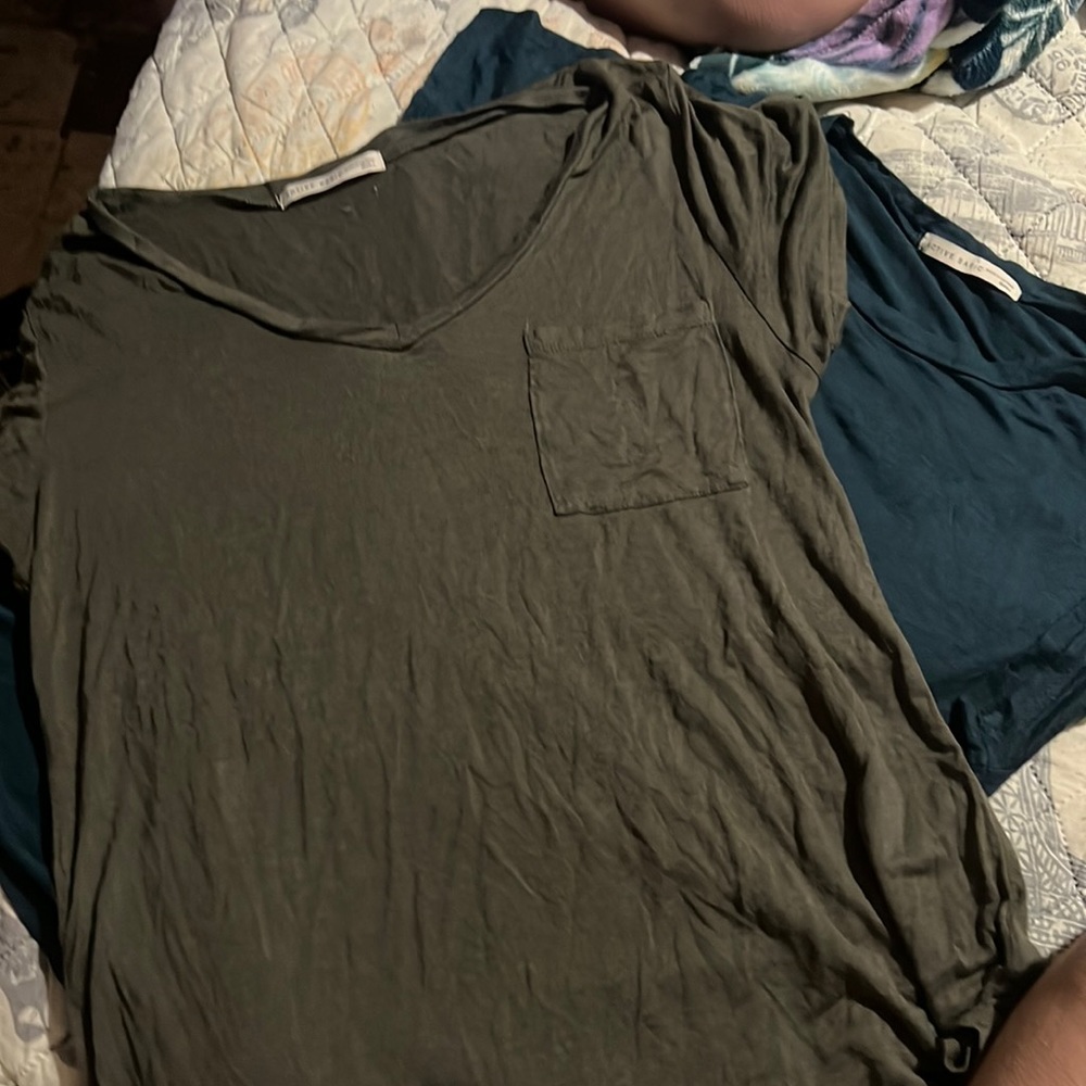 One green and one blue both size small tee shirts